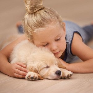 Girl laying on floor with her dog